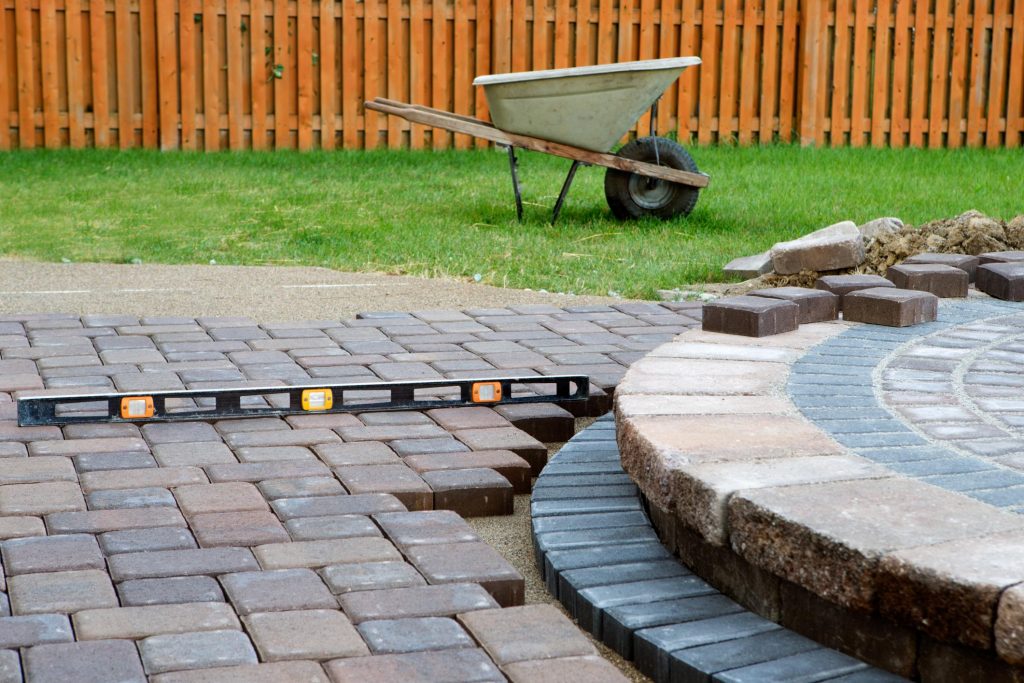 concrete brick tiles and a tool to check if its aligned