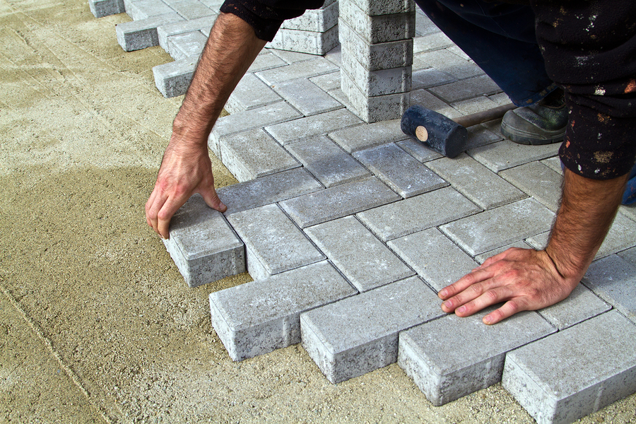 man putting concrete brick floor